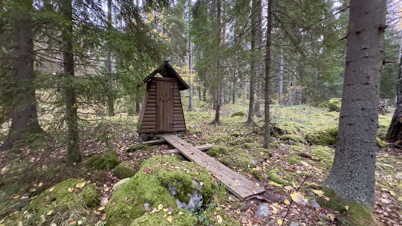 A dry toilet built of wood in the forest.