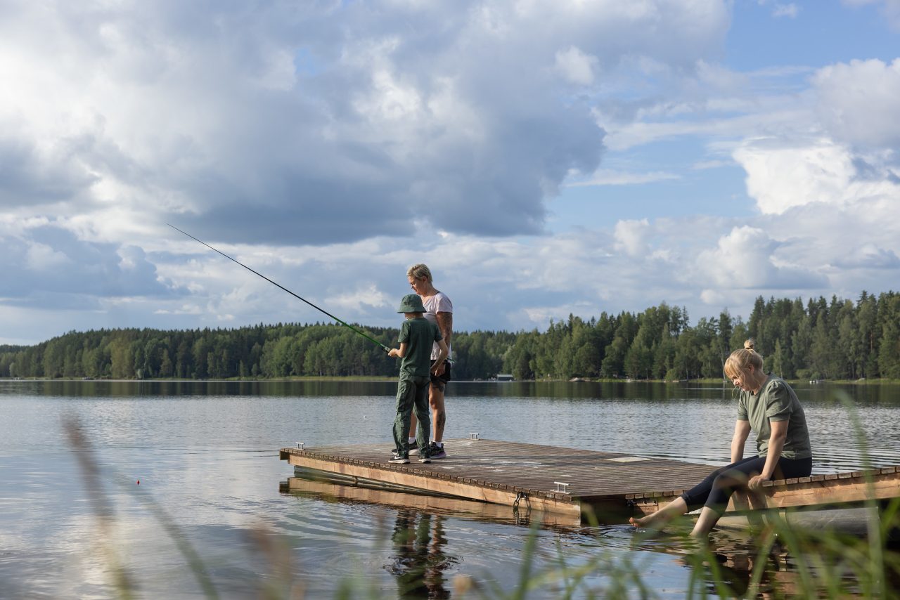 A woman and a child are angling on the jetty.