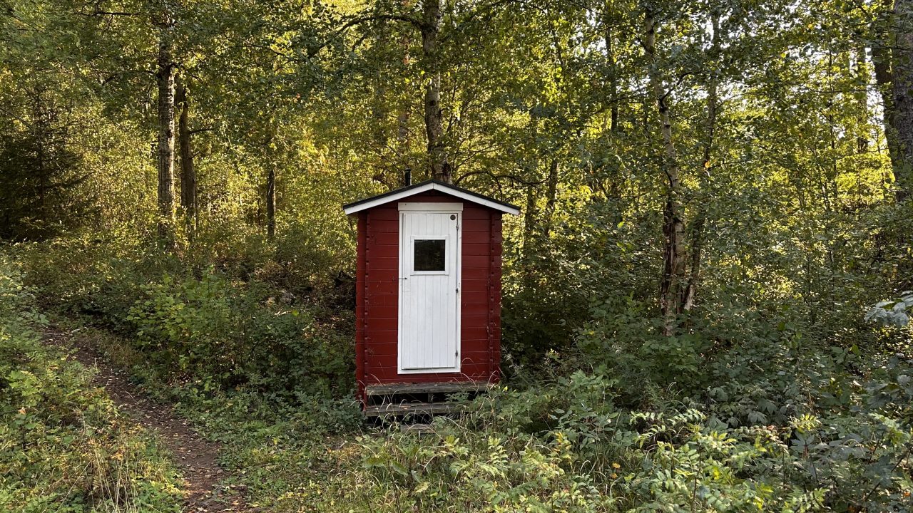 This is the red hut with a white door.